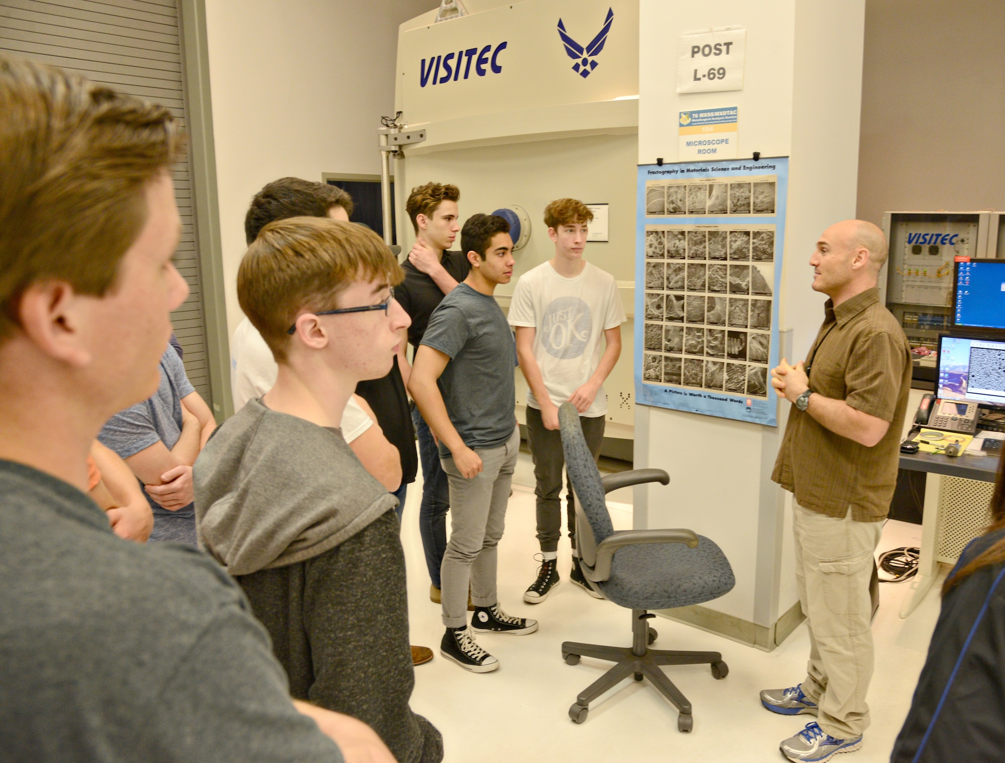Karl Koch, with the 76th Maintenance Support Group, briefs students from Francis-Tuttle Technology Center’s pre-engineering academy about the electron microscope laboratory and the world’s largest scanning electron microscope. They learned that the microscope helps with non-destructive inspections, and that it can help evaluate aircraft parts which have been overheated. (Air Force photo by Kelly White/Released)