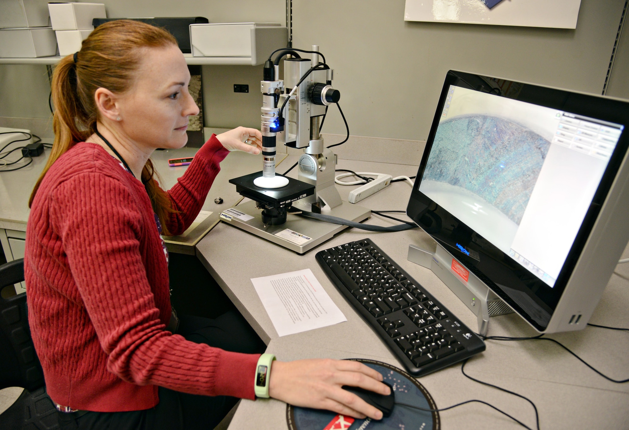 Jennifer Tromble scans a piece of metal 20 times to discover the piece sustained heat damage.  (Air Force photo by Kelly White/Released)