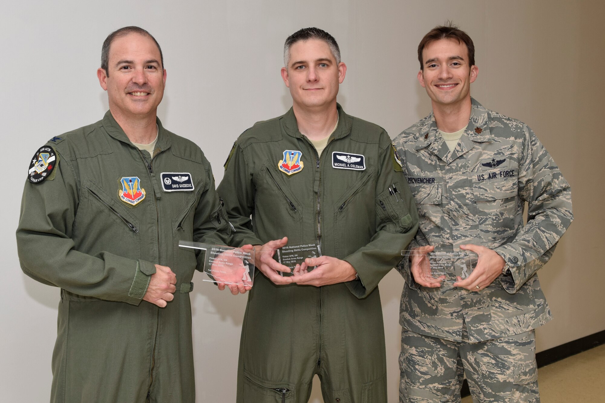 The team from the 552nd Air Control Wing, Air Combat Command, took home top honors for the highest team score during the Police Week 2016 pistol competition hosted by the 72nd Security Forces Squadron on Tuesday May 17, 2016, Tinker Air Force Base. Col. David Gaedecke, 552nd ACW commander, Lt. Col. Michael Coleman, 552nd inspector general, Maj. Matthew Provencher, 752nd Operations Support Squadron assistant director of operations, hold glass trophies after the competition results were annnounced. Not shown is the fourth team member, Maj. Neil Dimmitt, 552nd ACW deputy director of staff. (U.S. Air Force photo/Greg L. Davis)