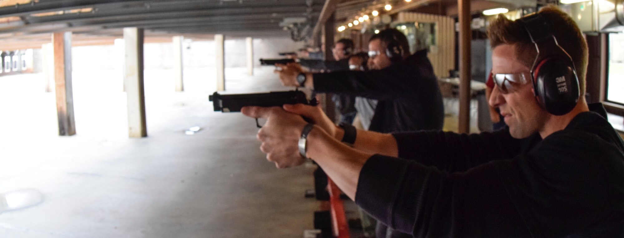Office of Special Investigations Special Agent Jesse Galvan leads the row of shooters competing in the 72nd Security Forces Squadron pistol competition held in conjunction with Police Week 2016 activities on Tuesday May 17, 2016, Tinker Air Force Base, Okla. The range, operated on Tinker AFB by the 72nd SFS, supports combat arms training for units from the Air Force, Navy and other law-enforcement units, as required. (U.S. Air Force photo/Greg L. Davis)