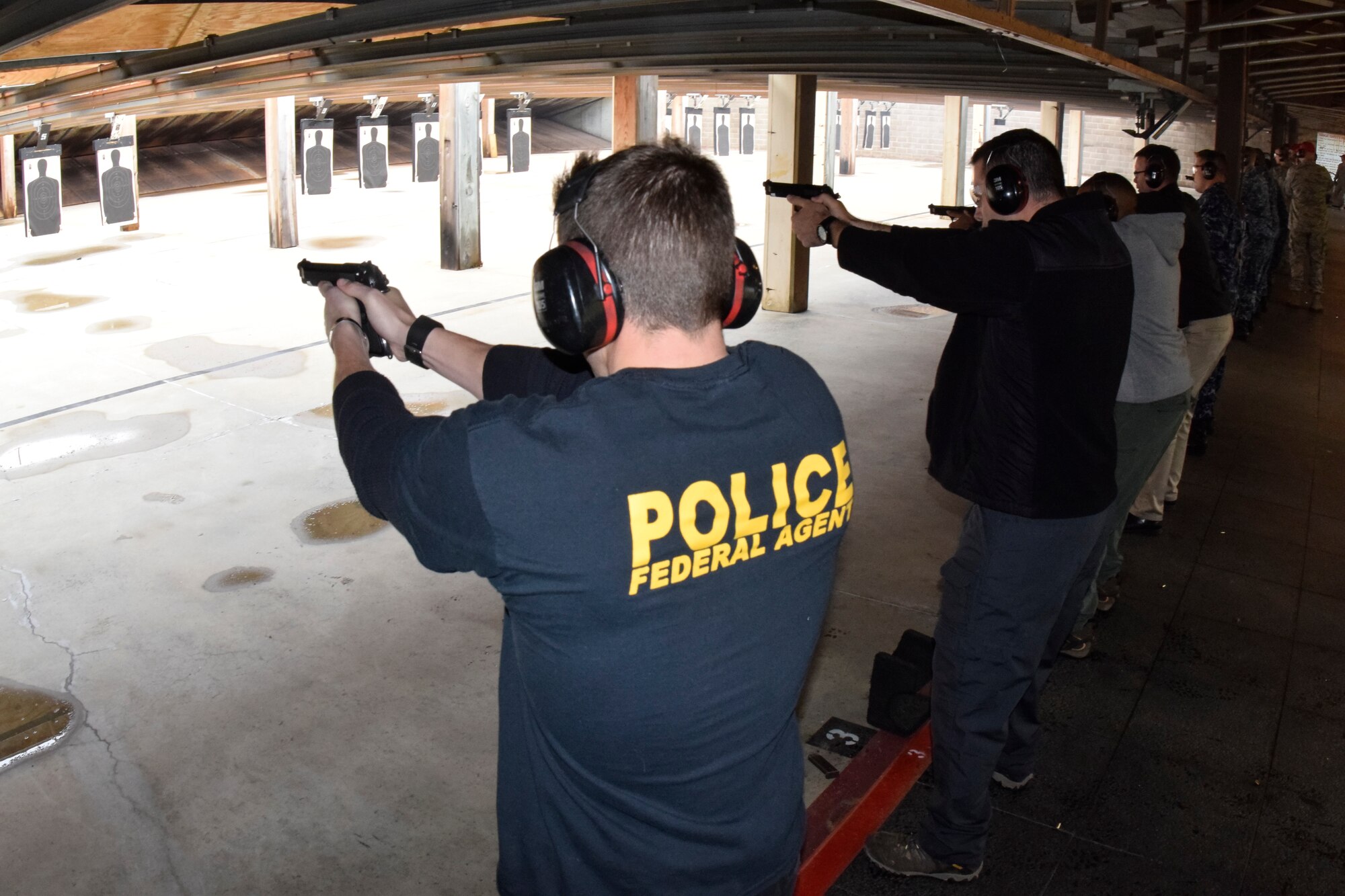 Office of Special Investigations Special Agent Jesse Galvan leads the row of shooters competing in the 72nd Security Forces Squadron pistol competition held in conjunction with Police Week 2016 activities on Tuesday May 17, 2016, Tinker Air Force Base, Okla. The range, operated on Tinker AFB by the 72nd SFS, supports combat arms training for units from the Air Force, Navy and other law-enforcement units , as required. (U.S. Air Force photo/Greg L. Davis)