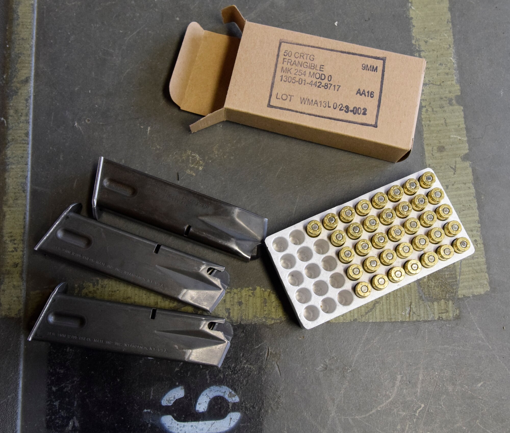 A box of 9mm ammunition and three pistol magazines sit on a table during the 72nd Security Forces Squadron pistol competition held in conjunction with Police Week 2016 activities on Tuesday May 17, 2016, Tinker Air Force Base, Okla. Shooters expended a total of 50 rounds each during the competition which challenged shooters in both speed and accuracy events. (U.S. Air Force photo/Greg L. Davis)