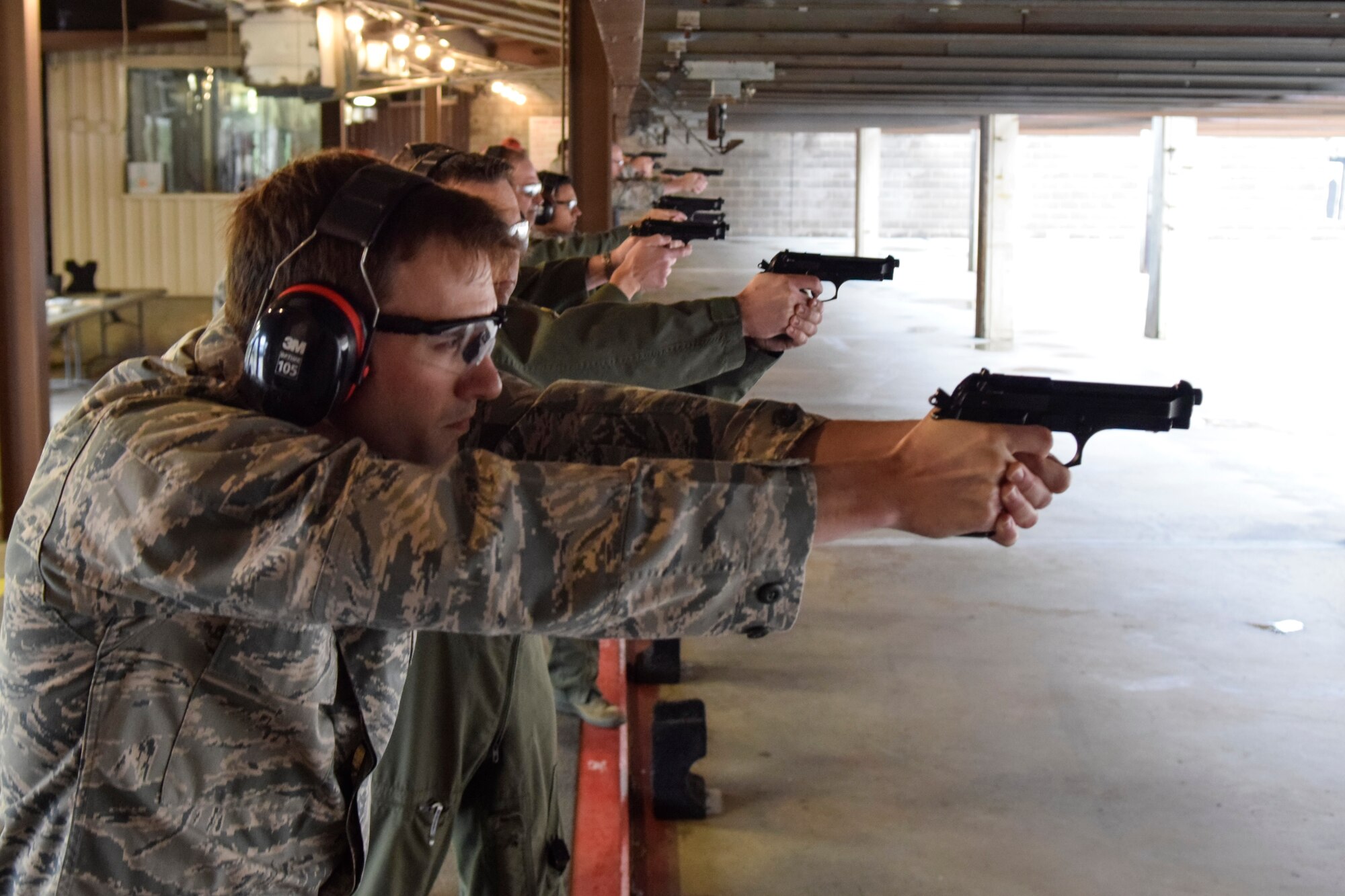 Maj. Matthew Provencher, 752nd Operations Support Squadron assistant director of operations takes aim with an Beretta M-9 pistol at the firing line during the 72nd Security Forces Squadron pistol competition held as part of Police Week 2016 activities on Tuesday May 17, 2016, Tinker Air Force Base, Okla. Provencher was part of the 552nd Air Control Wing's team which took the top shooting team prize. (U.S. Air Force photo/Greg L. Davis)