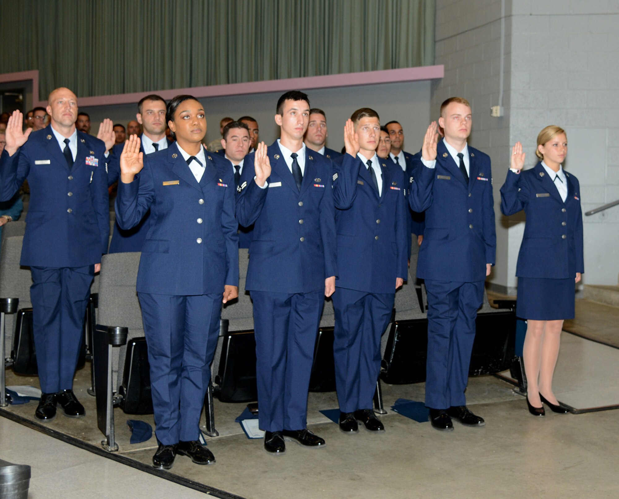 Airmen recite the oath of enlistment during a promotion ceremony here. Ceremony was performed by Secretary of the Air Force Deborah Lee James during her visit to Edwards Wednesday. (U.S. Air Force photo by Christopher Ball.)