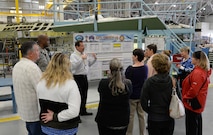 Brent Polglase, 573rd Aircraft Maintenance Squadron director, briefs a group of spouses during their visit to the F-16 Fighting Falcon production line May 25 at Hill Air Force Base, Utah. Polglase explained what it takes to perform depot maintenance and what impact it has on extending the service life of an F-16.  (U.S. Air Force Photo by Alex R. Lloyd)
