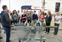 Terrell Lewis, Power Support System Mechanic, 581st Missile Maintenance Squadron, explains to spouses what a Launcher Equipment Room Shock Isolator is and what it is used for during the Team Hill spouses tour May 25 at Hill Air Force Base, Utah. The isolator is repaired and refurbished by workers in the 309th Missile Maintenance Group and is a small piece of the Minuteman III ICBM that is maintained by the group. (U.S. Air Force Photo by Alex R. Lloyd)