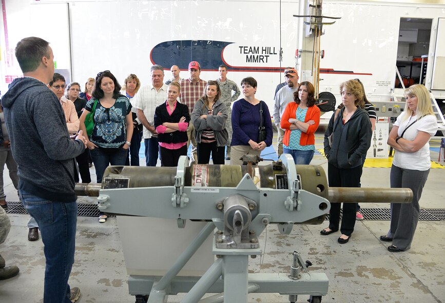 Terrell Lewis, Power Support System Mechanic, 581st Missile Maintenance Squadron, explains to spouses what a Launcher Equipment Room Shock Isolator is and what it is used for during the Team Hill spouses tour May 25 at Hill Air Force Base, Utah. The isolator is repaired and refurbished by workers in the 309th Missile Maintenance Group and is a small piece of the Minuteman III ICBM that is maintained by the group. (U.S. Air Force Photo by Alex R. Lloyd)