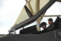 Capt. Derek Kirkwood, a pilot assigned to the 34th Fighter Squadron, dons his helmet in the cockpit of an F35A Lightning II aircraft April 22 at Hill Air Force Base, Utah. The sortie, the first F-35A 4-ship generation at the base, was part of a cross-ramp exercise and was a major test for the active duty 388th Fighter Wing and Reserve 419th Fighter Wing. The exercise helped identify process deficiencies before testing the F-35's operational agility at Mountain Home AFB, Idaho, in June. (U.S. Air Force photo by Paul Holcomb)