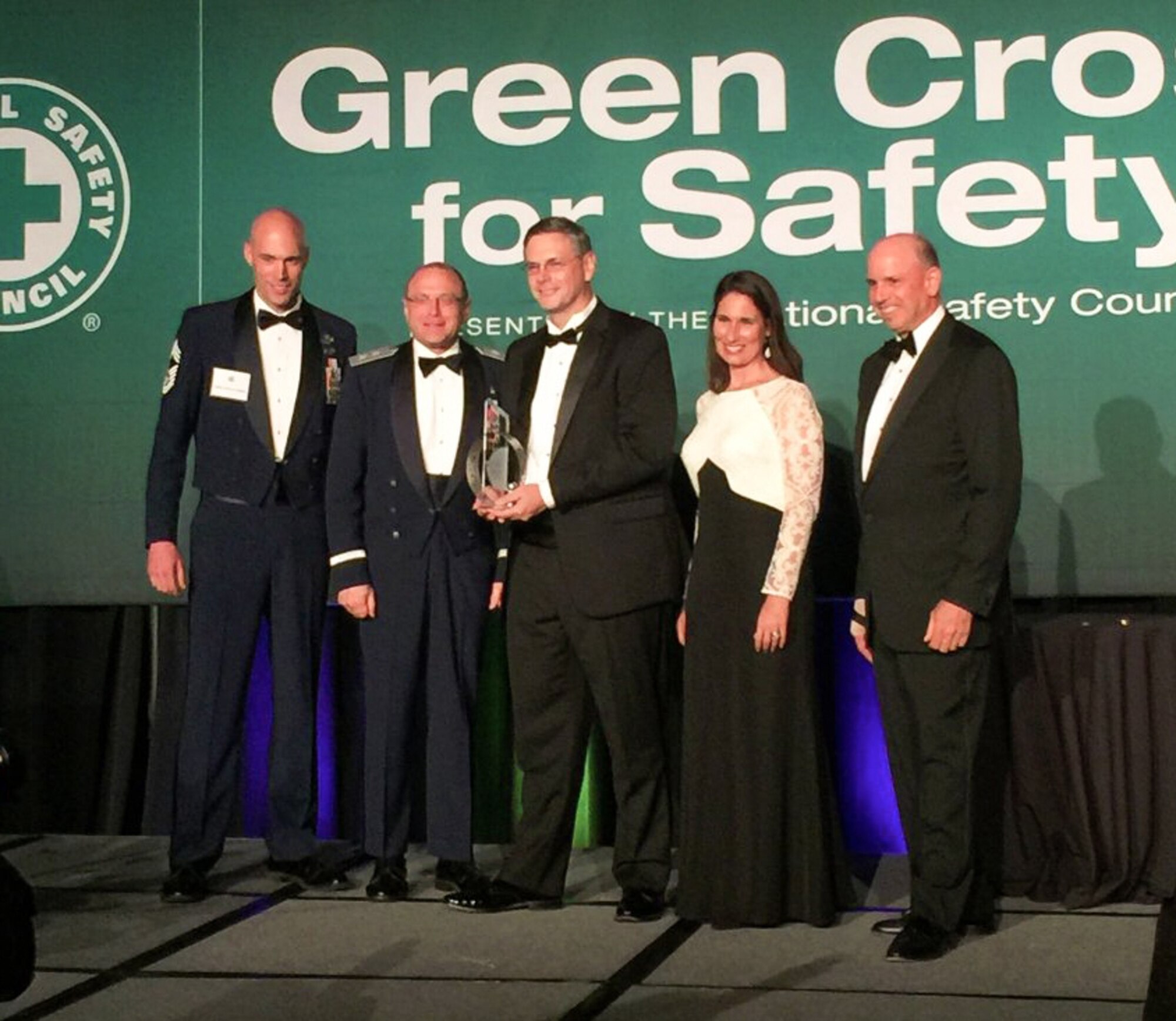 From left, Chief Master Sgt. Joshua J. Franklin, Air Force safety career field manager, and Maj. Gen. Andrew M. Mueller, chief of Air Force safety, were honored during the National Safety Council Green Cross Award ceremonies,  May 12, 2016, where they accepted the NSC Excellence Award on behalf of the  men and women of the Air Force Safety Center. Steve Sacco, center, vice president of safety for Schneider Electric, prepares to present the award along with Deborah Hersman, NSC president and CEO, and John Surma, NSC board chairman. (Courtesy photo)