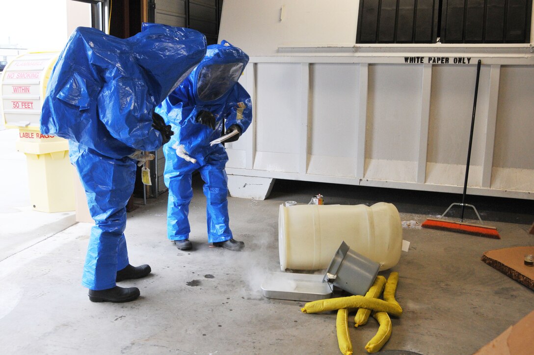 120th Airlift Wing Tech Sgt. Lee Dresch reads information found on chemical containers to Tech. Sgt. Dale Vig at a simulated hazardous material spill during a Hazardous Waste Operations and Emergency Response (HAZWOPER) class held at the 120th Airlift Wing in Great Falls Mont. May 20, 2016. The 120th AW offers a 40 hour course and 8 hour refresher course annually. (U.S. Air National Guard photo/Senior Master Sgt. Eric Peterson)   