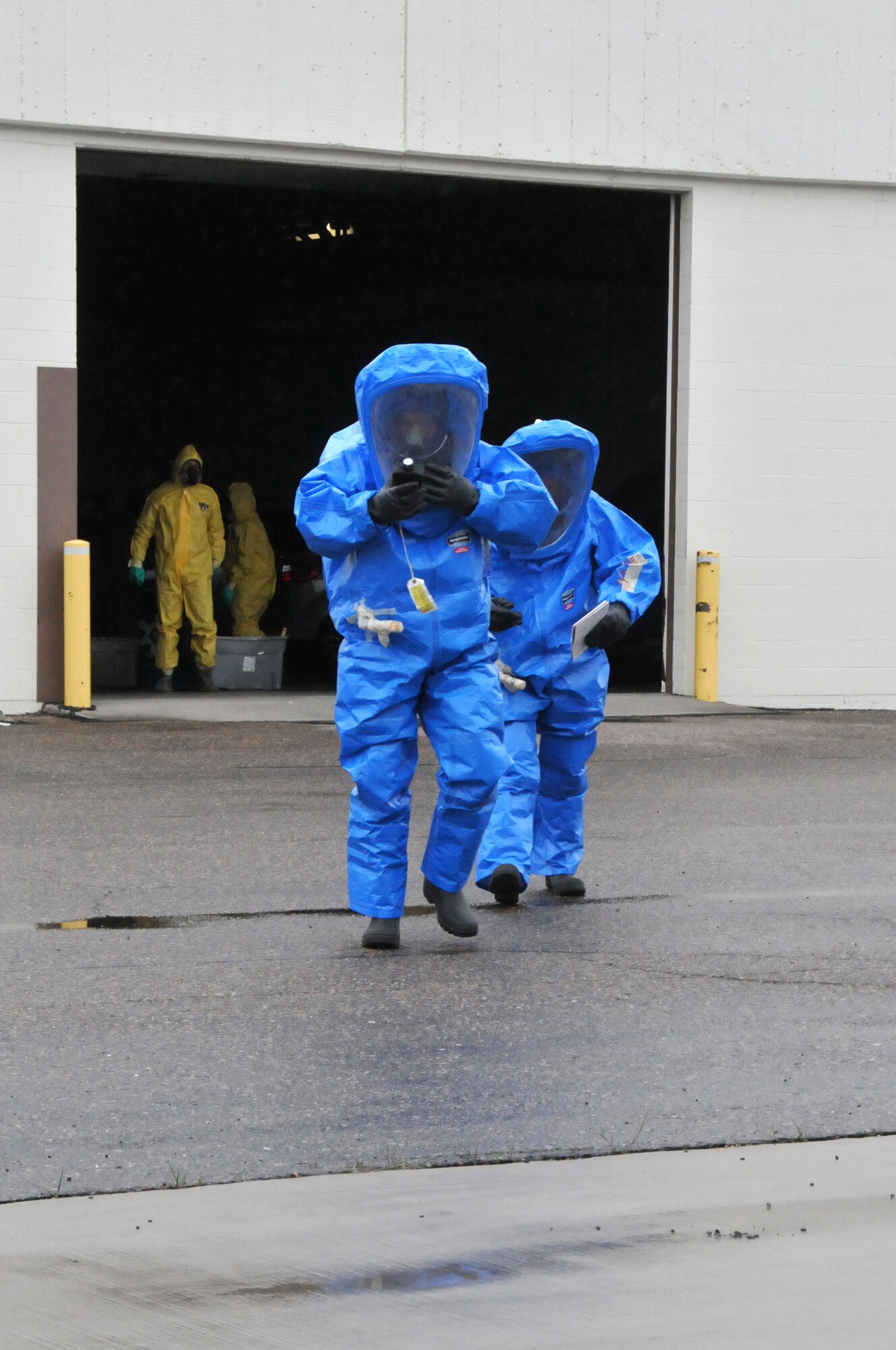 120th Airlift Wing members Tech. Sgt. Lee Dresch and Tech. Sgt. Dale Vig walk to a facility containing a simulated hazardous material spill during a Hazardous Waste Operations and Emergency Response (HAZWOPER) class held at the 120th Airlift Wing in Great Falls Mont. May 20, 2016. The 120th AW offers a 40 hour course and 8 hour refresher course annually. (U.S. Air National Guard photo/Senior Master Sgt. Eric Peterson)  