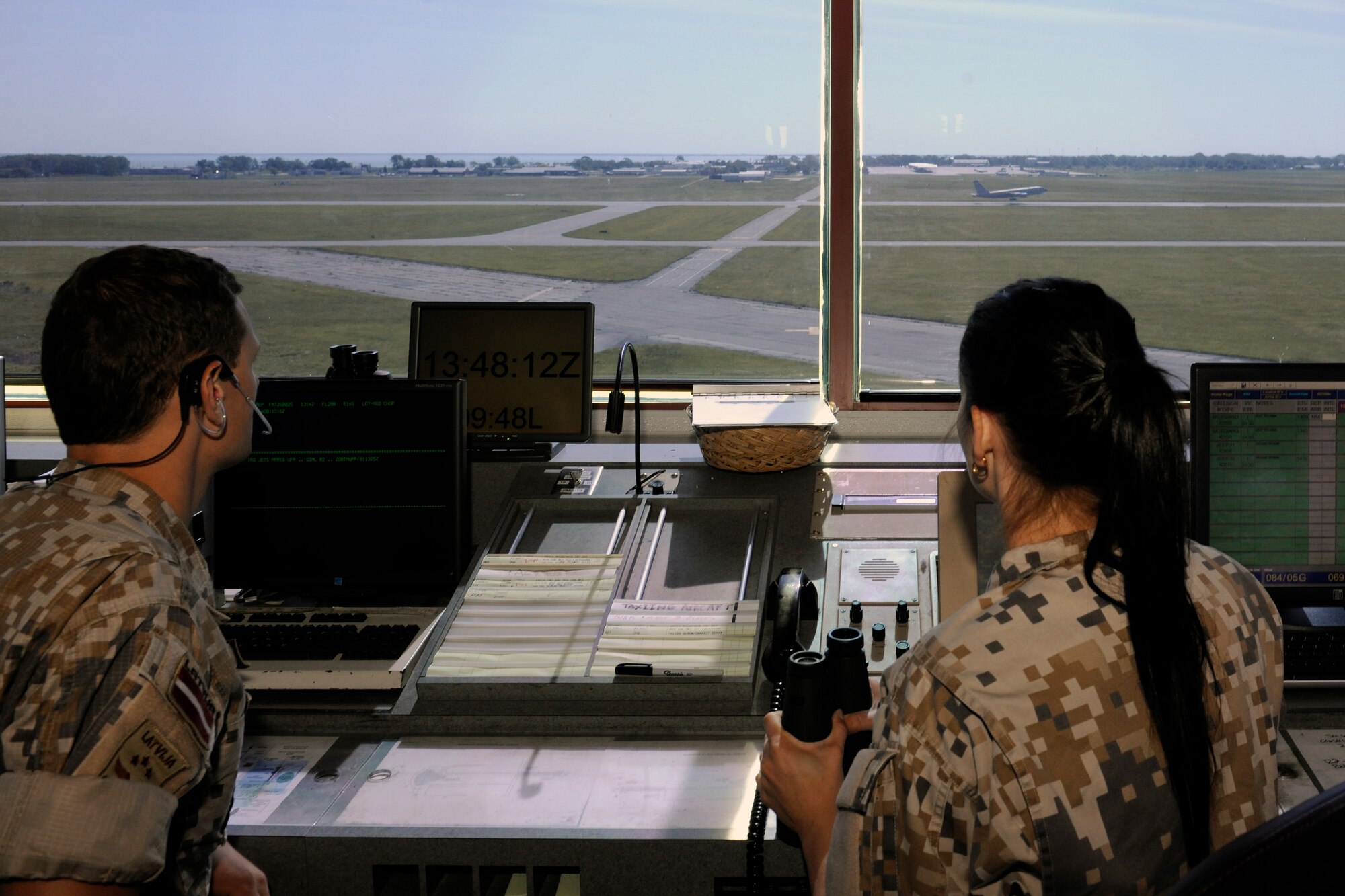 160601-Z-EZ686-012 -- Private Karl Grundins and Corporal Euija Polakova of the Latvian Air Force communicate with the pilots of a KC-135 Stratotanker during a takeoff at Selfridge Air National Guard Base in the early morning hours of June 1, 2016.  Grundins and Polakova participated in a working partnership between the Michigan National Guard and the Latvian military. (U.S. Air National Guard photo by Master Sgt. David Kujawa)