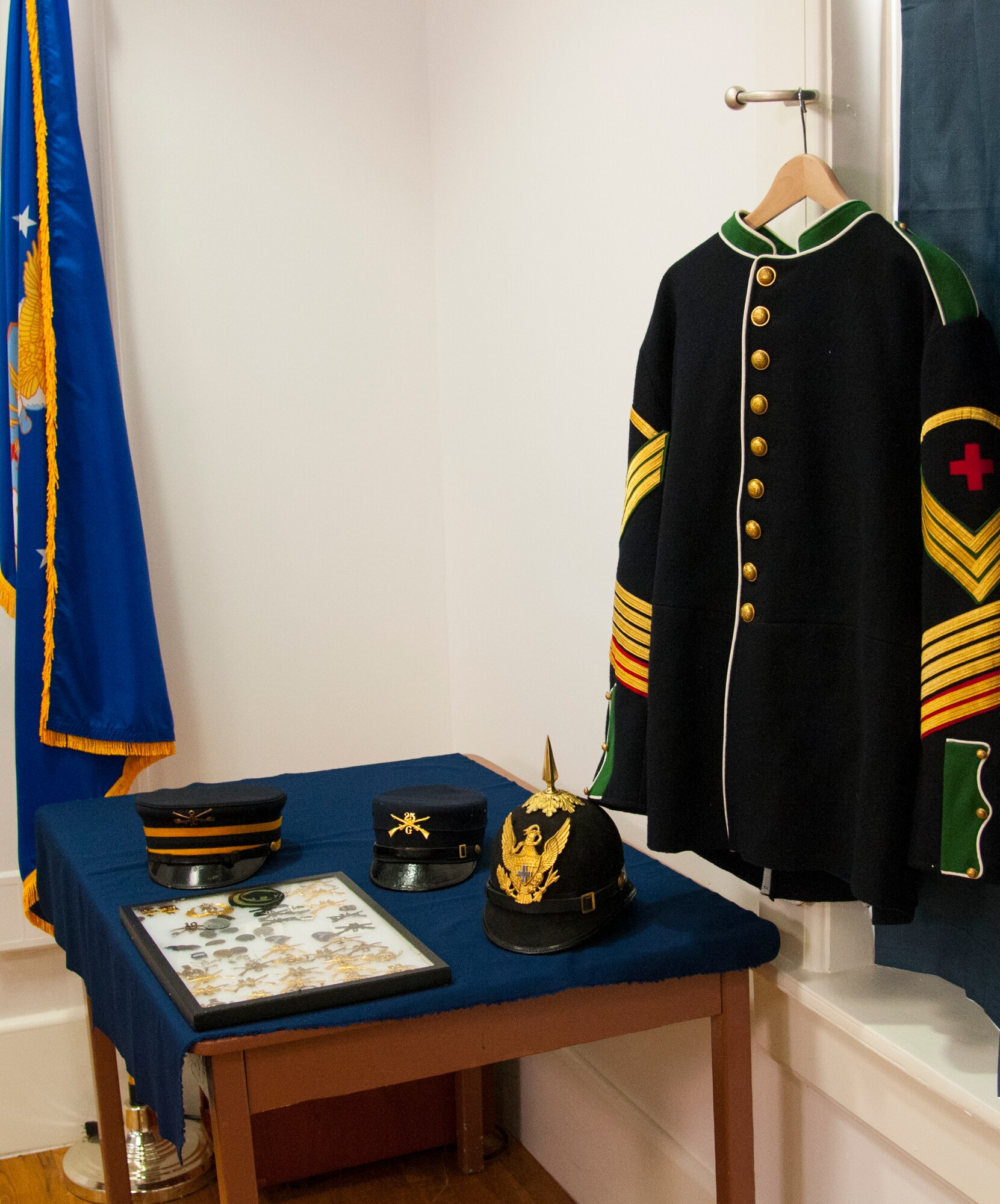 Examples of uniform items worn by Buffalo Soldiers, including a medical soldier's uniform top, various covers and a framed case of pins and devices, sit on display in the Warren ICBM & Heritage Museum on F.E. Warren Air Force Base, Wyo., June 1, 2016. The base spent more time as an Army post than it has an Air Force base, and during its history included a Buffalo Soldier units. (U.S. Air Force photo by Senior Airman Jason Wiese)