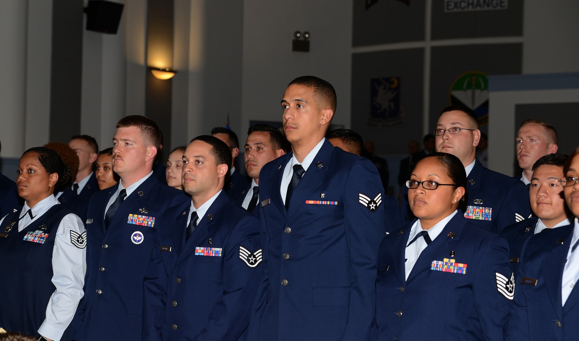 Community College of the Air Force graduates stand while being pronounced graduates at their graduation ceremony June 3, 2016 at Joint Base Lewis-McChord, Wash. More than 150 Team McChord Airmen earned CCAF Associate of Arts degrees. (U.S. Air Force photo/Senior Airman Jacob Jimenez)