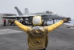 Navy Petty Officer 3rd Class Raimon Hubbard directs an F/A-18E Super Hornet on the flight deck of the aircraft carrier USS Harry S. Truman in the Mediterranean Sea, June 3, 2016. The USS Truman and its Carrier Strike Group are supporting Operation Inherent Resolve, maritime security operations and theater security cooperation efforts in the U.S. 6th Fleet area of operations. The Hornet is assigned to Strike Fighter Squadron 25. 