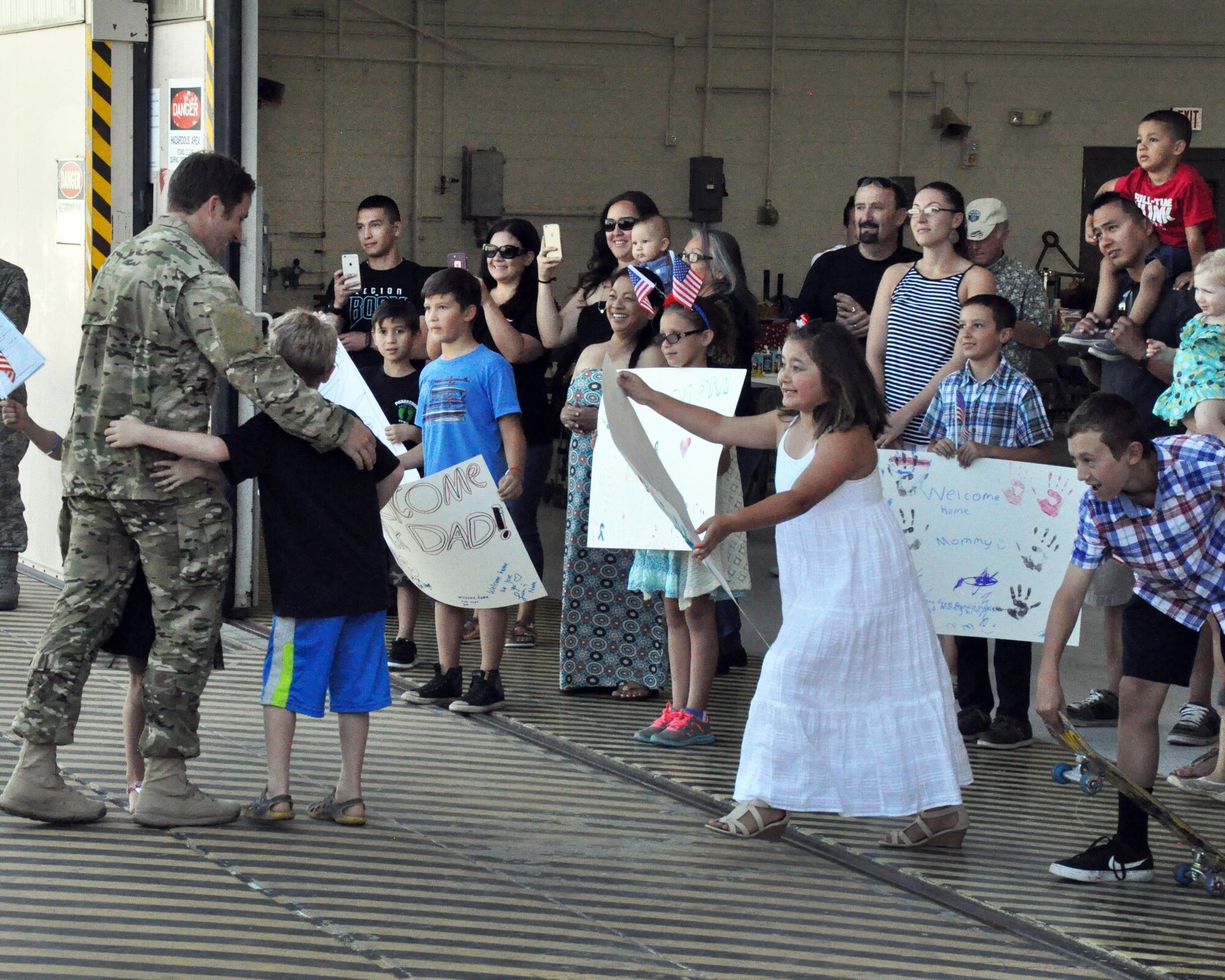 Families greet their loved ones upon the return of the 306th Rescue Squadron to Davis-Monthan Air Force Base, Ariz., from the Horn of Africa June 2. The 306th RQS is part of the 943rd Rescue Group, the Air Force Reserve Command's premier combat search and rescue group. They were deployed for four months and saved six lives during the deployment, flew more than 500 combat hours, conducted 67 parachute deployments, and provided more than 2,600 hours of dedicated alert coverage. (U.S. Air Force photo/Master Sgt. Greg Gaunt)