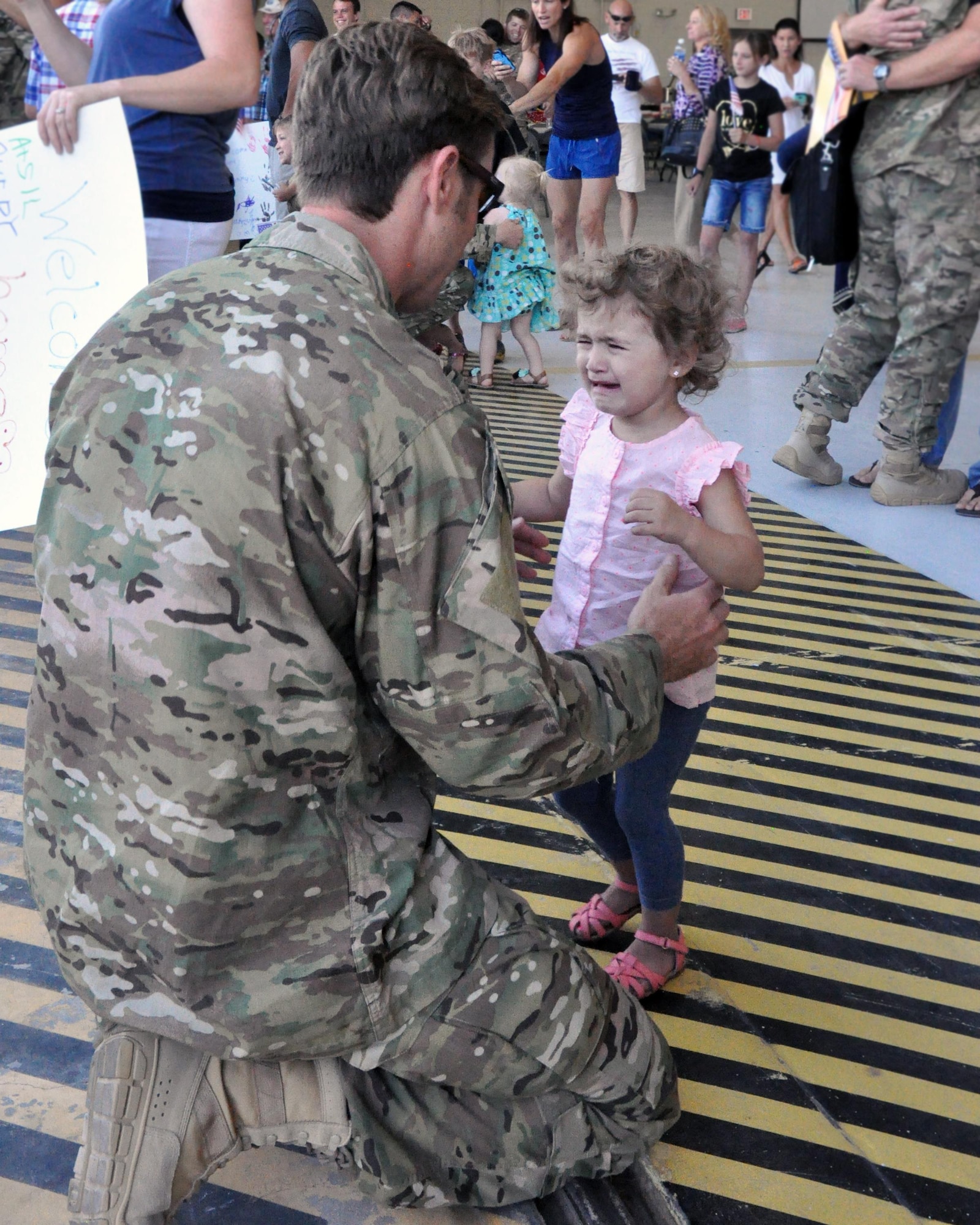 A little girl cannot contain her joy to see her father as he returns to Davis-Monthan Air Force Base June 2 from a 306th Rescue Squadron deployment to the Horn of Africa.  The 306th RQS is part of the 943rd Rescue Group, the Air Force Reserve Command's premier combat search and rescue group. As citizen Airmen, most of the men and women of the reserve rescue group here balance the unique requirements of a civilian career, a military career, and family. (U.S. Air Force photo/Master Sgt. Greg Gaunt)