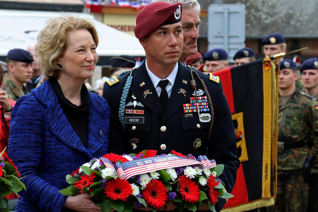Susan Eisenhower, granddaughter of Gen. Dwight Eisenhower, and Lt. Col. Justin Resse, commander of 1st Battalion, 508th Parachute Infantry Regiment, prepare to lay a wreathe in a joint ceremony with the French and Germans to commemorate the 72nd Anniversary of D-Day in Sainte-Mère-Église, France, June 2, 2016. Army photo by Capt. Joe Bush
