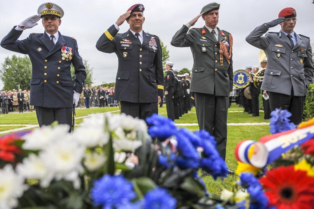 Army Lt. Gen. Stephen J. Townsend, right center, commander of the 18th Airborne Corps, renders a salute, alongside representatives of the French and German militaries, to a memorial dedicated to the 502nd Parachute Infantry Regiment, 101st Airborne Division during a memorial in Carentan, France, June 3, 2016. Air Force photo byStaff Sgt. Timothy Moore