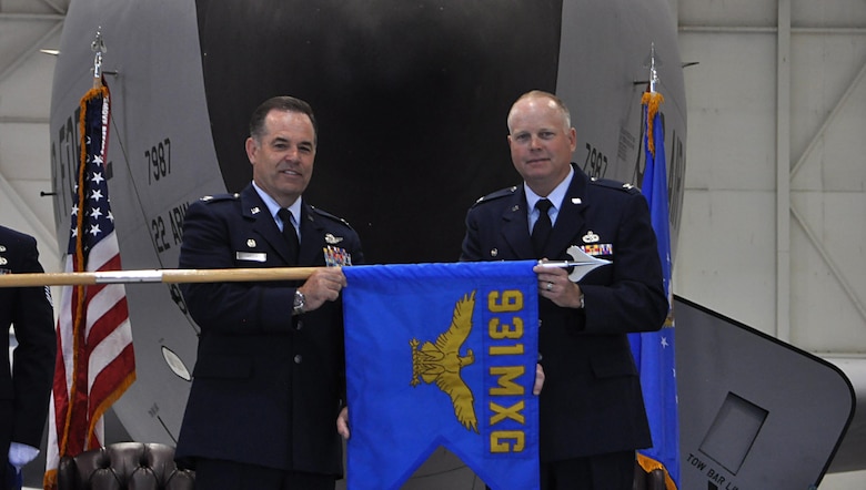 Col. Mark S. Larson, left, 931st Air Refueling Wing commander, and Col. Heath Fowler, 931st Maintenance Group commander, unfurl the 931 MXG guidon during an activation and assumption of command ceremony June 4, 2016, in Hangar 1107 at McConnell Air Force Base, Kansas. Traditionally, a new guidon is unfurled when a unit is activated, re-designated or receives a new permanent mission. (U.S. Air Force photo by Senior Airman Preston Webb)