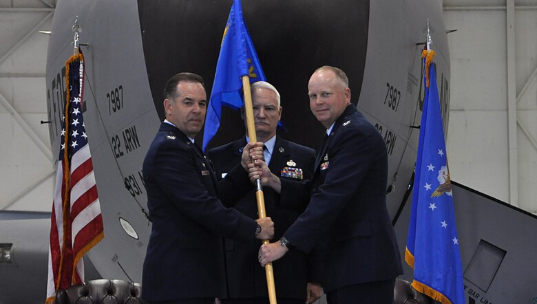 Col. Mark S. Larson, left, 931st Air Refueling Wing commander, passes the 931 MXG guidon to Col. Heath Fowler, 931st Maintenance Group commander, during an activation and assumption of command ceremony June 4, 2016, in Hangar 1107 at McConnell Air Force Base, Kansas. The passing of the guidon serves as the official marker for the transfer of authority from one commander to the next. (U.S. Air Force photo by Senior Airman Preston Webb)