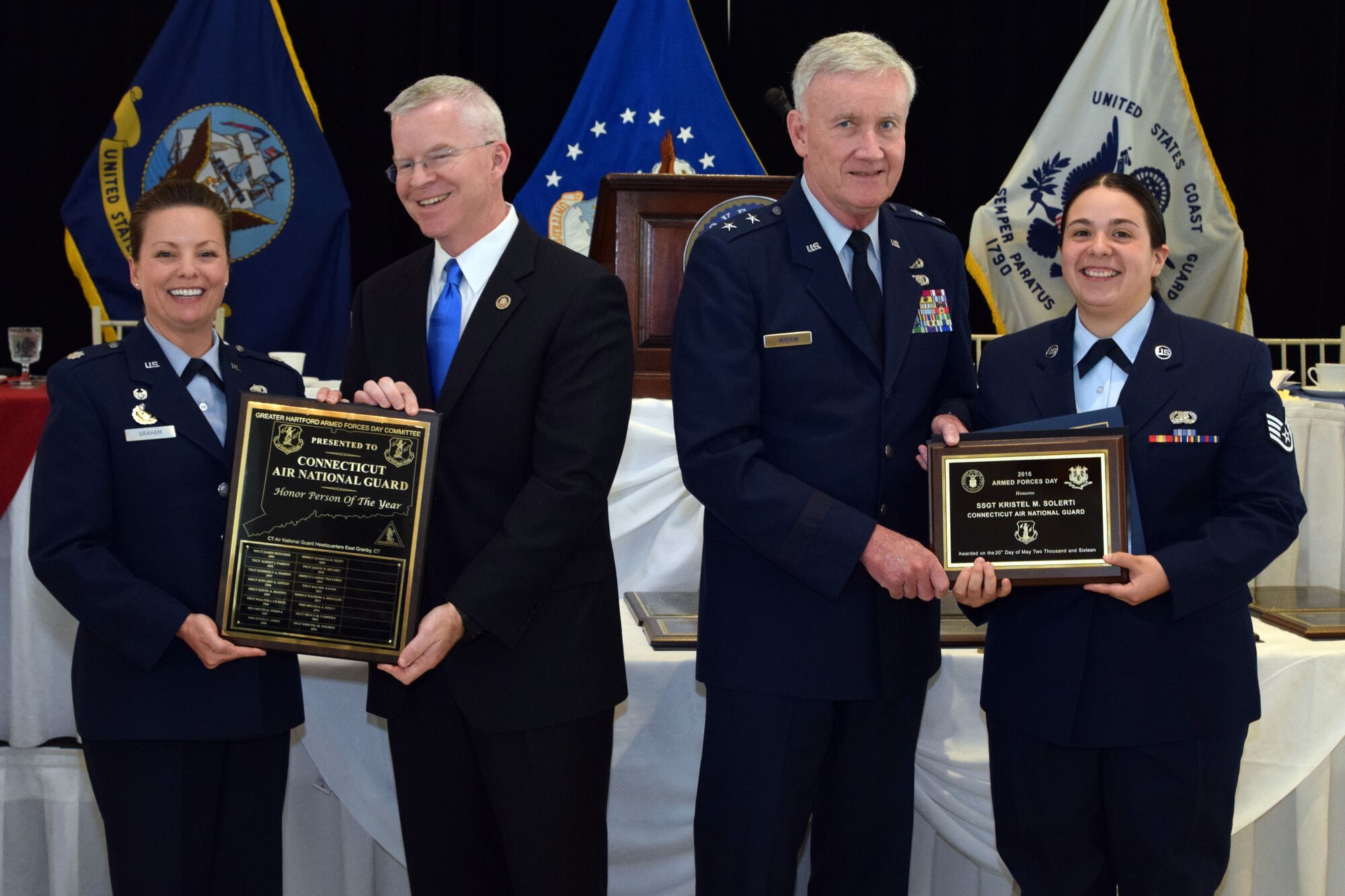 Staff Sgt. Kristel M. Solerti (far right), a personnelist with the 103rd Force Support Squadron is presented the award as the 2016 Armed Forces Day luncheon honoree for the Connecticut Air National Guard by (left to right) Lt. Col. Kristine Graham, commander, 103rd FSS, Sean Connolly, Commissioner of the Connecticut Department of Veterans Affairs and Maj. Gen. Thad Martin, Adjutant General of the Connecticut National Guard. (Photo by Staff Sgt. Benjamin Simon, JFHQ Public Affairs, CTARNG)