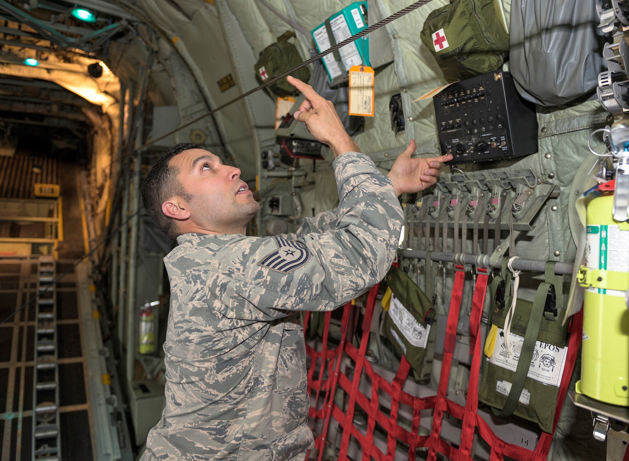 U.S. Air Force Tech. Sgt. Jose A. Ruiz, a crew chief cross-training to become a C-130 flight engineer with the 169th Airlift Squadron, Illinois Air National Guard, demonstrates the different settings of jump lights on a C-130 Hercules aircraft in Peoria, Ill., April 30, 2016. Ruiz, a first-generation American with Mexican heritage, said a good thing about diversity in the military is that it allows everyone to experience the differences between cultures and backgrounds. (U.S. Air National Guard photo by Staff Sgt. Lealan Buehrer)