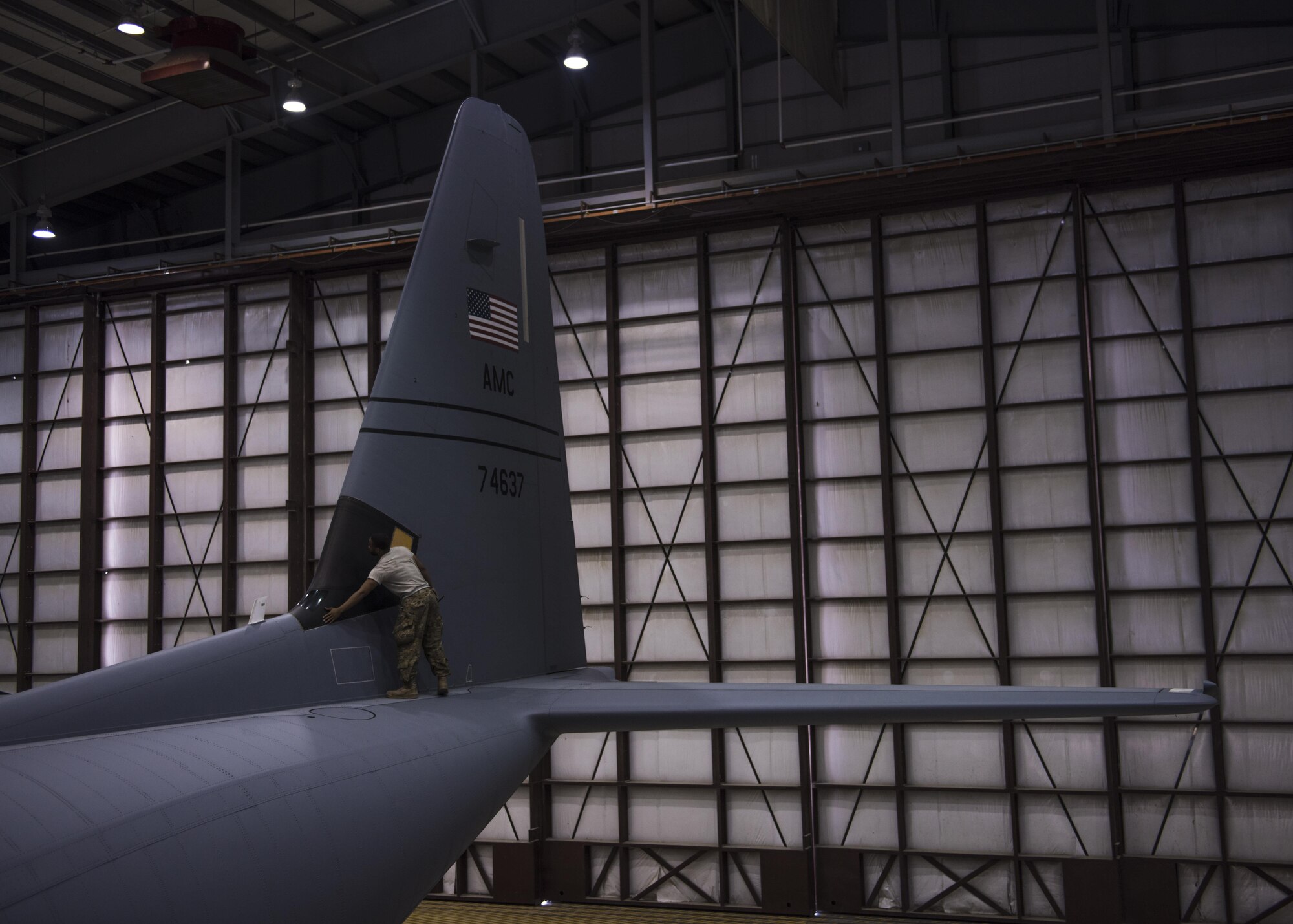 Senior Airman Shannon Wilson, 455th Expeditionary Aircraft Maintenance Squadron crew chief, inspects the tail of a C-130J Super Hercules for imperfections at Bagram Airfield, Afghanistan, June 04, 2016. After a C-130J has flown several missions, it undergoes a 500-hour inspection to look for damage or imperfections. (U.S. Air Force photo by Senior Airman Justyn M. Freeman)