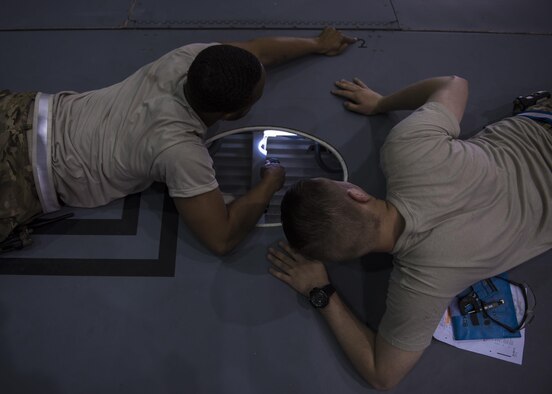 Senior Airman Shannon Wilson (left), 455th Expeditionary Aircraft Maintenance Squadron crew chief, and Senior Airman Spencer Kennedy (right), 455th EAMXS aircraft metals technology technician, identify a bolt hole that needs to be inspected inside a C-130J Super Hercules wing at Bagram Airfield, Afghanistan, June 04, 2016. Kennedy measured the bolt hole to make sure no elongation has occurred and the part doesn't need to be replaced. (U.S. Air Force photo by Senior Airman Justyn M. Freeman)