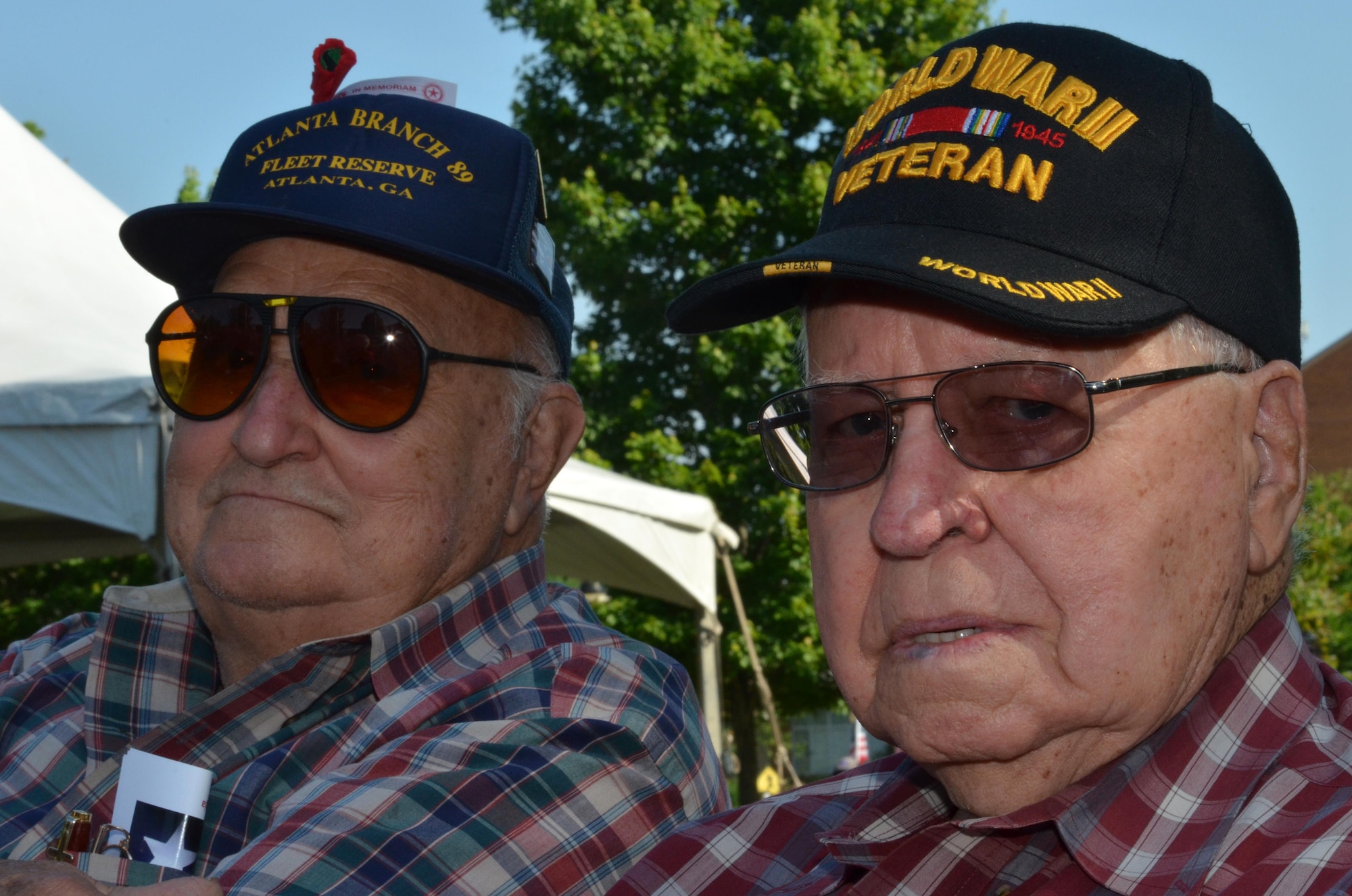 Retired Army Staff Sergeant and Korean and Vietnam war veteran, Joe Farquhar, sits next to Petty Officer Weldon Crane, WWII veteran and Smyrna resident during a Memorial Day Ceremony held in Smyrna, Ga., May 30, 2016. During the ceremony, Maj. Gen. Stayce Harris, 22nd Air Force commander, spoke to a large crowd and elaborated that the nation recognizes the loss of life from war and that those who perished fill the burial grounds in towns and cities all across the country and abroad. (U.S. Air Force photo/Tech. Sgt. Kelly Goonan)