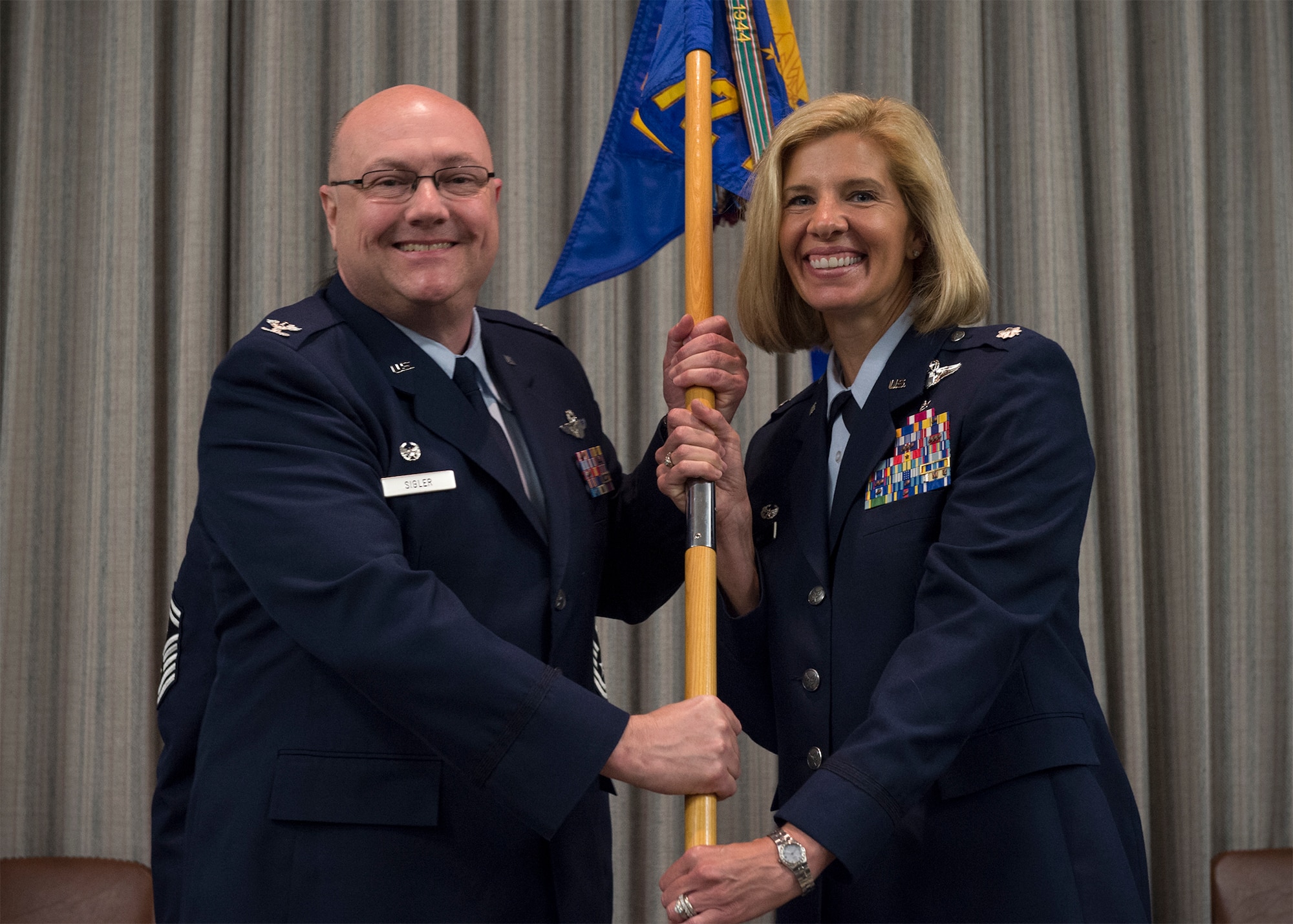 Lt. Col. Anne Noel, right, accepts the guidon and command of the 72nd Air Refueling Squadron from Col. Mark Sigler, 434th Operations Group Commander and officiating officer, during a change of command ceremony at Grissom Air Reserve Base, Ind., June 4, 2016. Noel previously served at Grissom as a KC-135R Stratotanker instructor pilot, evaluator pilot and operations officer from 2005 to 2015. (U.S. Air Force photo/Staff Sgt. Katrina Heikkinen)