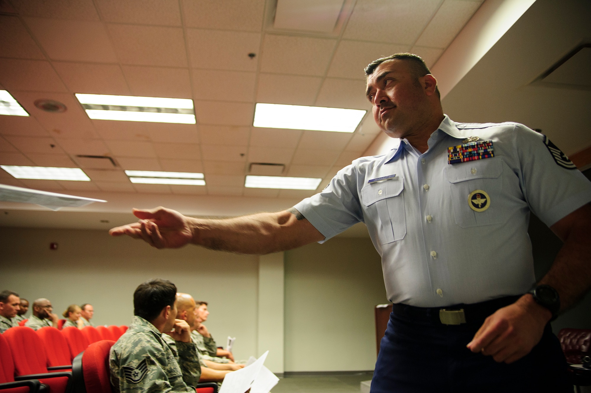 Master Sgt. Jose Rodriguez, a military training instructor supervisor with the 433rd training squadron at JB San Antonio-Lackland, Texas, provides a brochure to an instrested MTI canidate during a briefing June 5, 2016 at Joint Base Charleston, South Carolina. The MTI recruiting team was conducting a nationwide search for new military training instructors from the Air Force Reserve (U.S. Air Force photo by Senior Airman Jonathan Lane).