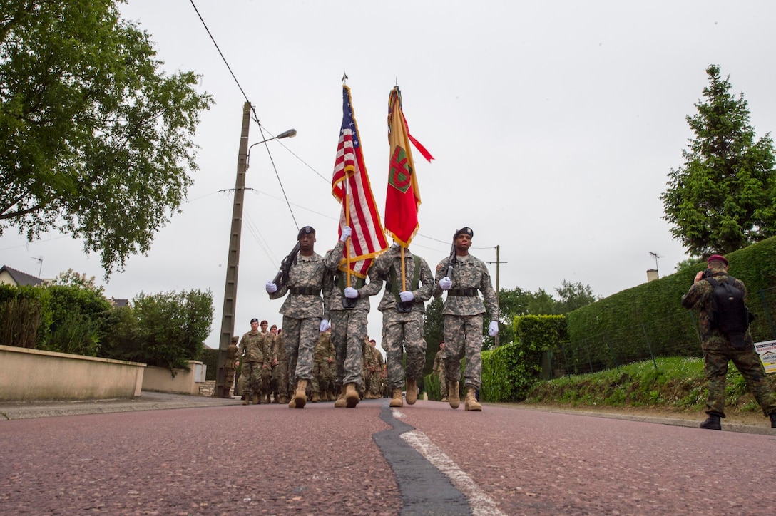 U.S. soldiers march in formation to the 90th Infantry Division Monument Memorial Ceremony to commemorate D-Day in Picauville, France, June 3, 2016. Navy photo by Petty Officer 1st Class Sean Spratt 
