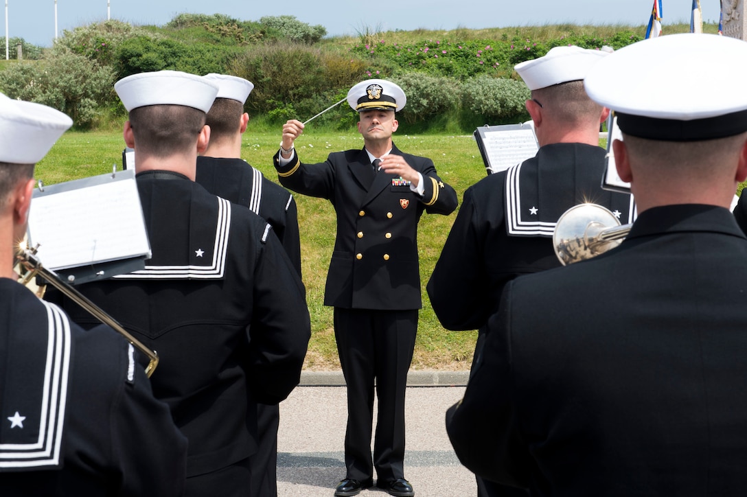 The U.S. Naval Forces Europe Band plays the national anthem during the Utah Beach Memorial Ceremony to honor the sacrifices of WWII veterans in Normandy, France, June 4, 2016.  Navy photo by Petty Officer 1st Class Sean Spratt