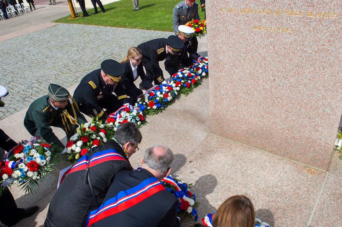 Service members from the U.S., France and Germany, along with government officials, lay ceremonial wreaths at the Utah Beach Memorial Ceremony, Normandy, France, June 4, 2016. Utah Beach was the code name given to the westernmost landing beach for the invasion of Normandy. Navy photo by Petty Officer 1st Class Sean Spratt