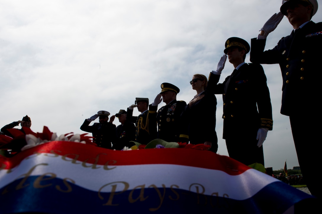 Service members from the U.S., France and Germany salute during the playing of the national anthems at the Utah Beach Memorial Ceremony in Normandy, France, June 4, 2016. U.S. forces landed 23,250 troops on Utah Beach during D-Day. Navy photo by Petty Officer 1st Class Sean Spratt