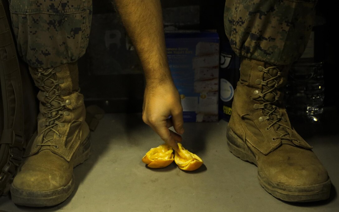 Sgt. Anthony Bradley eats an orange after a training day, May 12, 2016, at Camp Rodriguez Live Fire Complex, South Korea. Bradley is an engineer equipment operator and is in charge of preparing the range’s terrain during Korea Explosive Ordnance Explosive Exercise. He is from Bowling Green, Ky., and is attached to Support Company, 9th Engineer Support Battalion, III Marine Logistics Group, III Marine Expeditionary Force. (U.S. Marine Corps photo by Cpl. Isaac Ibarra/Released)