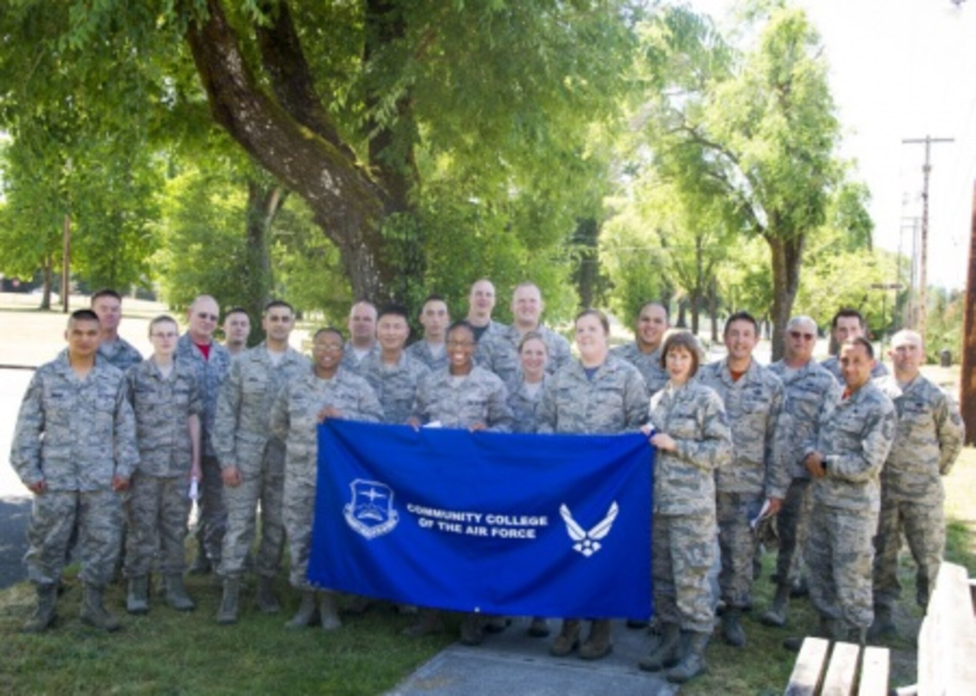 Members of the 446th Airlift Wing stand with a Community College of the Air Force banner after their graduation ceremony on Joint Base Lewis-McChord, June 4. The 446th graduated 87 from the wing and five members earned two degrees. The Community College of the Air Force has awarded 101 Associate and Applied Science degrees to members of the 446th AW during this cycle. (U.S. Air Force Reserve photo by SSgt. Daniel Liddicoet)