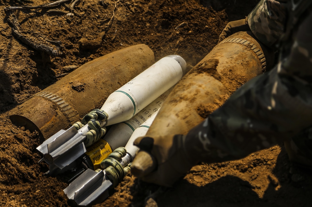 A U.S. soldier sets up a shot with two unexploded 155mm projectiles and three M853/A1 81MM illumination mortars, May 21, 2016 at Montana Range, South Korea. U.S. Marine and U.S. Soldier Explosive Ordnance Explosive technicians participated in Korea EOD Exercise to further familiarize themselves with ordnance and render-safe procedures. The Soldiers are with 718th EOD Company, 23rd Chemical Battalion, 2nd Infantry Division. The Marines are with 3rd EOD Company, 9th Engineer Support Battalion, 3rd Marine Logistics Group, III Marine Expeditionary Force. (U.S. Marine Corps photo by Cpl. Isaac Ibarra/Released)