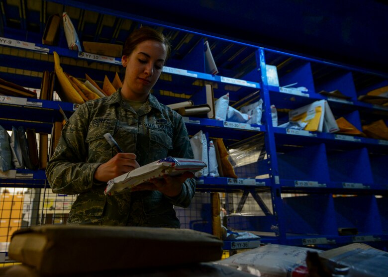 Airman 1st Class Jillian Koontz, 51st Communications Squadron postal clerk, enters packages into a tracking system before being sorted for final delivery at Osan Air Base, Republic of Korea, June 3, 2016. Each package is individually tracked and processed to ensure quick and proper delivery. (U.S. Air Force photo by Senior Airman Victor J. Caputo/Released)