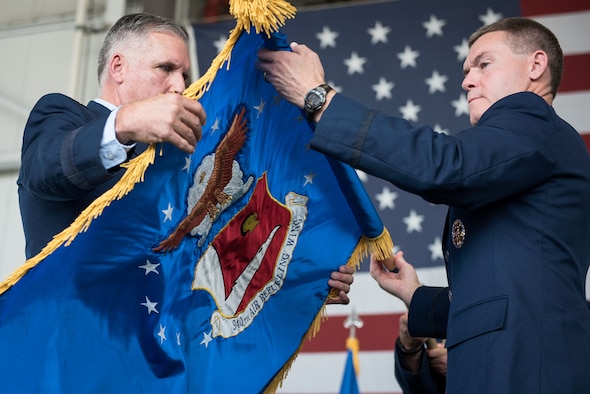 Col. Craig Peters, 940th Air Refueling Wing commander, unfurls the renewed 940 ARW flag at the 940th Air Refueling Wing re-designation ceremony and leadership assumptions of command this past weekend at Beale Air Force Base, California. (U.S. Air Force photo by Staff Sgt. Brenda Davis/released)