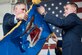 Col. Craig Peters, 940th Air Refueling Wing commander, unfurls the renewed 940 ARW flag at the 940th Air Refueling Wing re-designation ceremony and leadership assumptions of command this past weekend at Beale Air Force Base, California. (U.S. Air Force photo by Staff Sgt. Brenda Davis/released)
