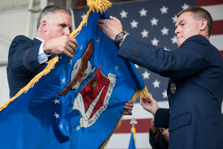 Col. Craig Peters, 940th Air Refueling Wing commander, unfurls the renewed 940 ARW flag at the 940th Air Refueling Wing re-designation ceremony and leadership assumptions of command this past weekend at Beale Air Force Base, California. (U.S. Air Force photo by Staff Sgt. Brenda Davis/released)