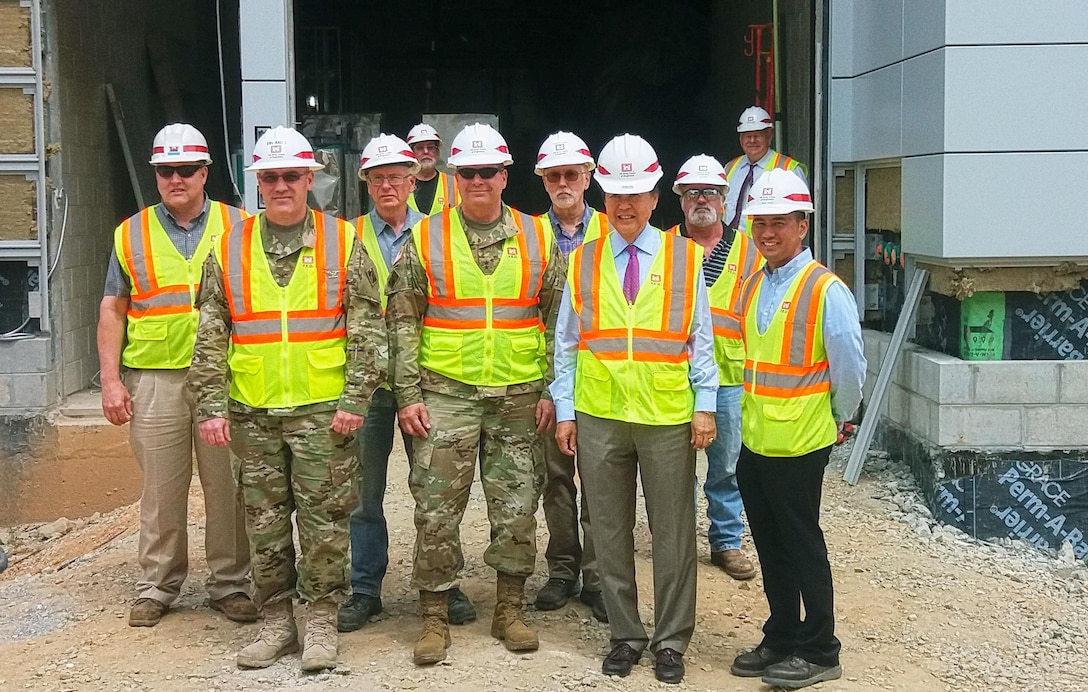 Maj. Gen. Mark W. Yenter, Deputy Commanding General for Military and International Operations, (front center), Gene Ban, Programs Director for the Pacific Ocean Division, U.S. Army Corps of Engineers (front, second from right), Col. Stephen H. Bales, Far East District Commander (front, left), along with other members of the Far East District, pose for a photo during a tour of the medical and dental complex construction site at U.S. Army Garrison Humphreys.

Yenter is visiting the Republic of Korea to view construction progress on the Korea Relocation Program and to participate in the Eighth Army rehearsal of concept drill, which prepares units moving out of Seoul and areas near the Demilitarized Zone to the central hubs of Camp Humphreys and U.S. Army Garrison Daegu.