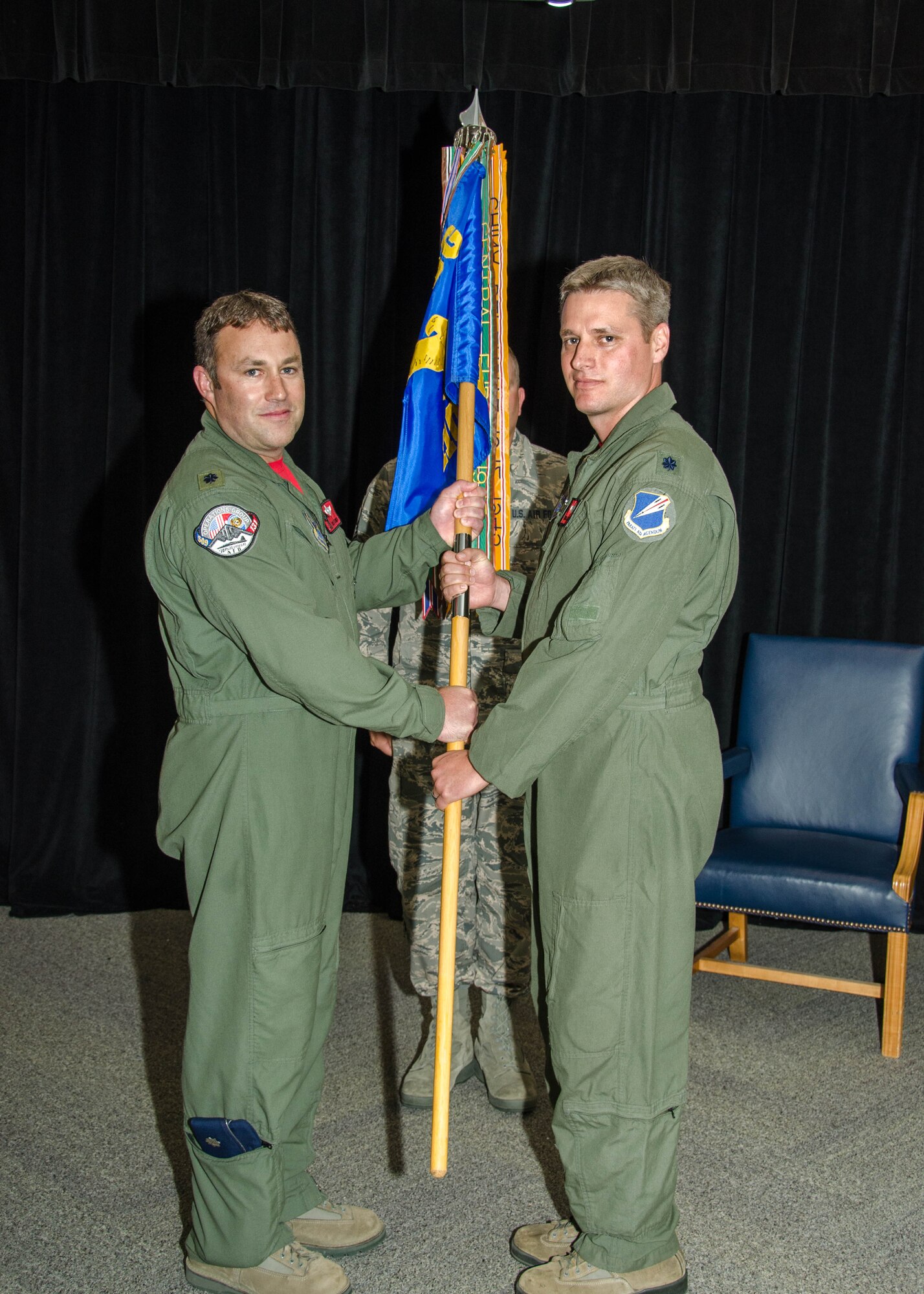 Lt. Col. Timothy Rezac accepts the 110th Bomb Squadron guidon from Lt. Col. Jared Kennish, 131st Operations Group commander, during Rezac's assumption of command ceremony at Whiteman Air Force Base, Missouri, June 5, 2016. Rezac, who was previously chief of safety for the 131st, was joined by friends and family at the ceremony. (U.S. Air National Guard photo by Airman 1st Class Halley Burgess)