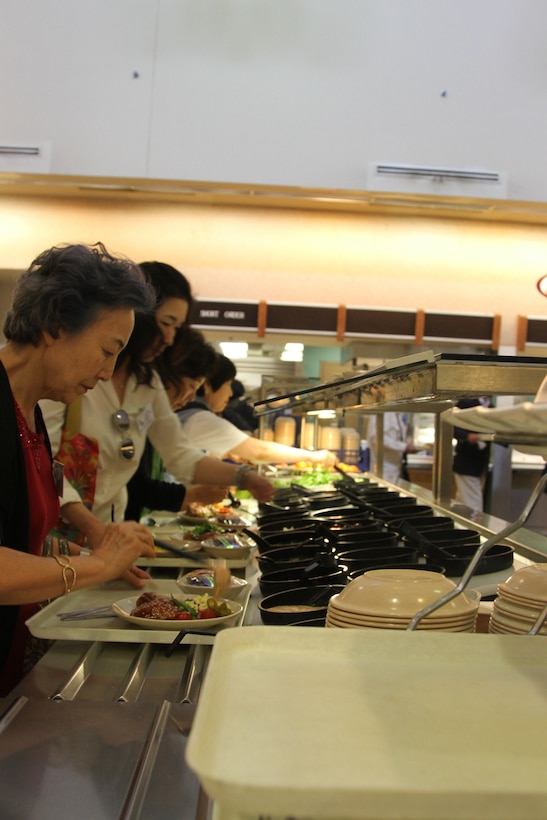 Members of the Korean-American Society and the People to People International-Korea eat lunch in Provider Dining Facility on Camp Humphreys. The groups were there to tour both Humphreys and Osan Air Base as part of the Executive Orientation Program II. They learned about U.S. Army's plan to relocate troops and their famillies from Seoul to Camp Humphries. 