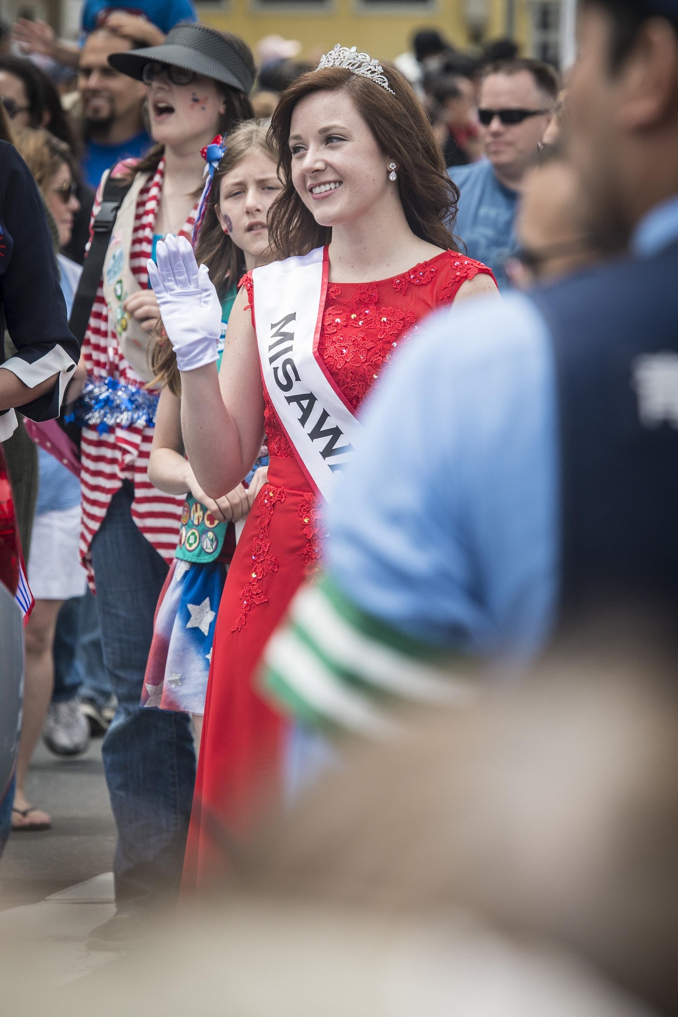 U.S. Air Force Senior Airman Taryn Mendoza, the 28th Annual American Day queen and an allergy and immunization technicians with the 35th Medical Operations Squadron, smiles and waves as she walks by attendees during the parade in Misawa City, Japan, June 5, 2016. More than 80,000 attendees from across the Aomori Prefecture traveled to Misawa City to enjoy American and Japanese culture. Serving as the American Day queen is a two-year honor requiring applicants to compete in numerous events testing their merit and propensity as a queen. Mendoza said she’s truly humbled to have been a part of the event. She hails from Pocatello, Idaho. (U.S. Air Force photo by Staff Sgt. Benjamin W. Stratton)