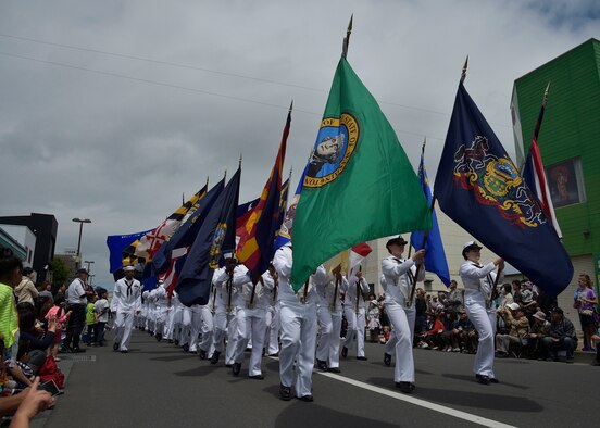 U.S. Navy Sailors with the Naval Air Facility-Misawa march with 50 state flags during the 28th Annual American Day parade in Misawa City, Japan, June 5, 2016. Events like these are important as they afford Misawa neighbors, American and Japanese alike, opportunities to interact in a relaxed environment specifically planned for building friendships. More than 80,000 attendees enjoyed live performances, including Sublime with Rome, indulge in American and Japanese cuisine and to strengthen international bonds. (U.S. Air Force photo by Senior Airman Deana Heitzman)