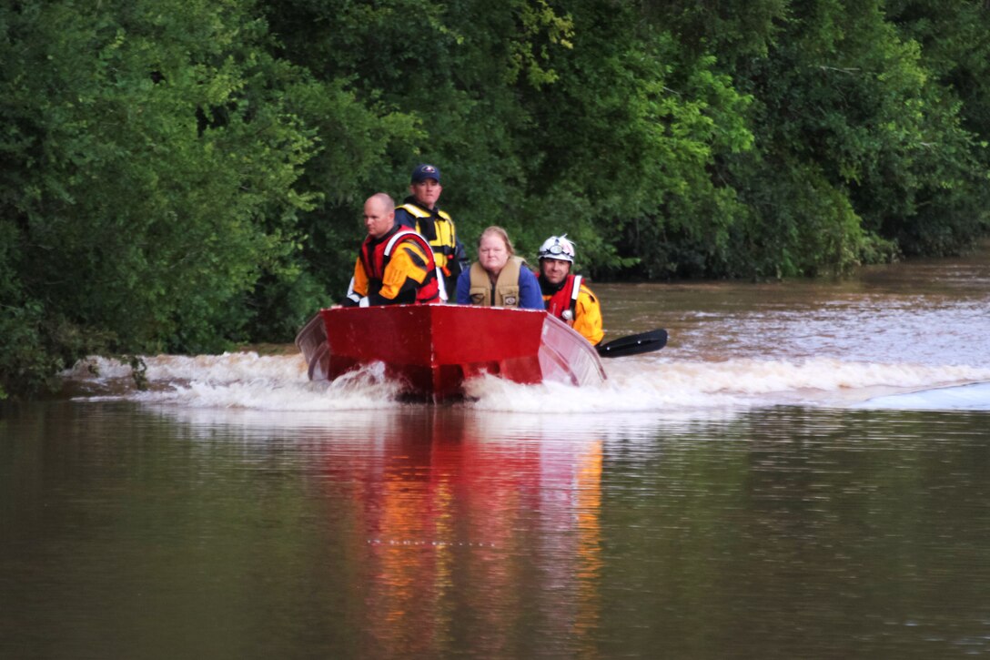 Texas first responders transport a stranded resident to a waiting vehicle during severe flooding in Rosenberg, Texas, June 3, 2016. Texas Army National Guard photo by Staff Sgt. Timothy Pruitt