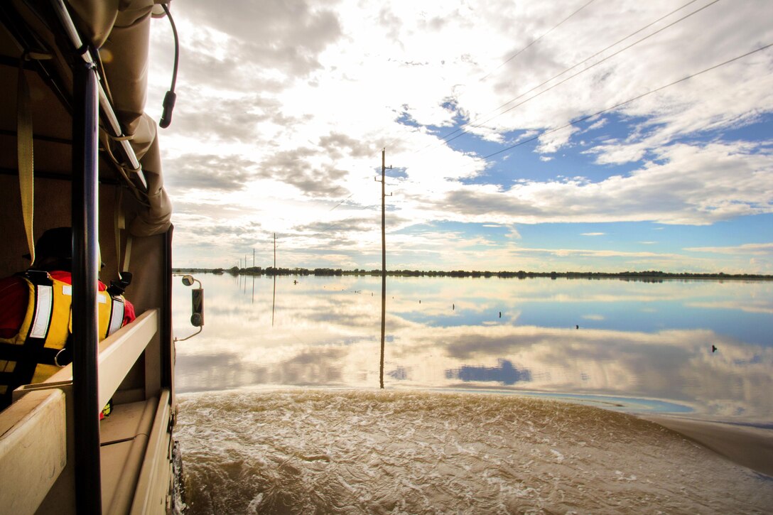 Soldiers drive a light multi-terrain vehicle down a flooded road to search for stranded residents during severe flooding in Rosenberg, Texas, June 3, 2016. Texas Army National Guard photo by Staff Sgt. Timothy Pruitt